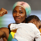Shelly-Ann Fraser-Pryce of Jamaica celebrates with her son Zyon after winning the Women’s 100 Metres final during day three of 17th IAAF World Athletics Championships Doha 2019 on Sept. 29, 2019, in Doha, Qatar.